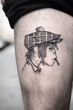 a woman with a hat on her head is shown from the thigh up, while she's wearing a black and white tattoo