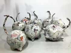 several pieces of art made out of paper mache apples and pears on a table