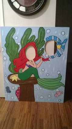 the little mermaid is sitting on top of a potted plant