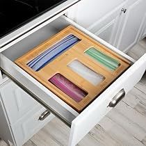 an open drawer in the middle of a kitchen