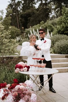 Red and pink wedding theme at Middleton Lodge. The bride wears a Chosen by Kyha dress with puff sleeves adorned with pearls and Chanel shoes. Pink And Red Wedding Groomsmen, Light Pink And Red Wedding, Pink Red Wedding Theme, Pink And Red Bridesmaid Dresses, Cherry Red Wedding, Pink And Red Wedding Theme, Red Pink Wedding, Red Black And White Wedding