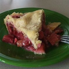 a piece of pie sitting on top of a green plate