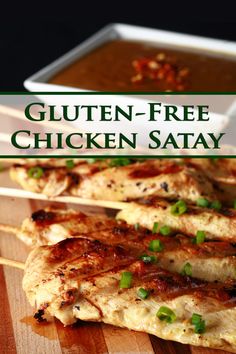 grilled chicken on skewers with sauce and green onion garnishes