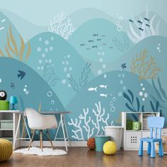 an ocean scene with fish and corals painted on the wall in this children's room