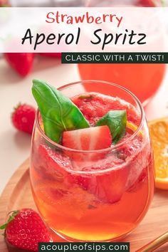 strawberry aperol spritz in a glass with basil garnish