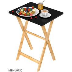 a small table with a plate of food on it next to a cup of coffee