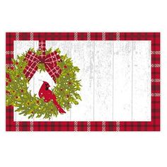 a red and white checkered table cloth with a cardinal wreath on the front of it