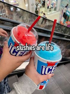 two people holding up ice creams in front of an escalator with the caption slushies are life