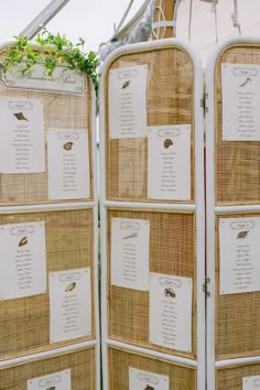 a close up of a room divider made out of wicker with seating cards on it