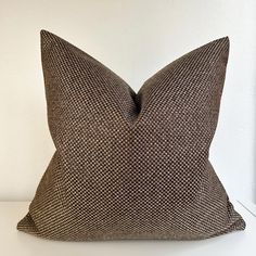 a brown pillow sitting on top of a white table