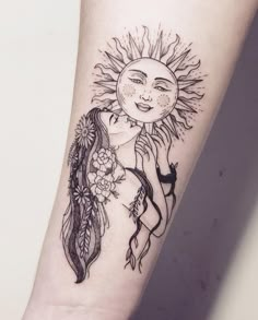 a woman's arm with a sun and feathers tattoo design on the left forearm