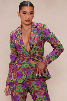 a woman in a colorful suit posing for the camera