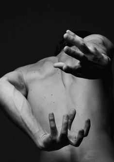 black and white photograph of a man's back with his hands in the air