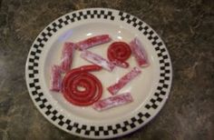 a plate that has some kind of candy on it with red candies in the middle