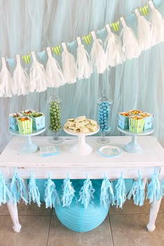 a table topped with desserts and cupcakes on top of it