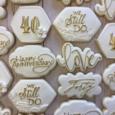 decorated cookies are displayed on a table for an anniversary party or special occasion to celebrate