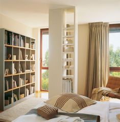 a bedroom with bookshelves and a bed in it