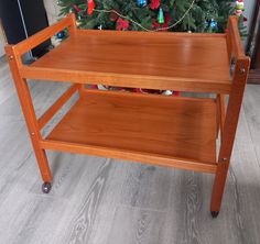 a wooden table with a christmas tree in the background