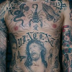 a man with many tattoos on his chest