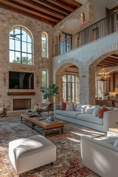 a large living room with high ceilings and stone walls