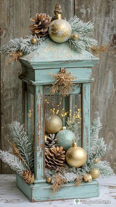 an old lantern with ornaments and pine cones