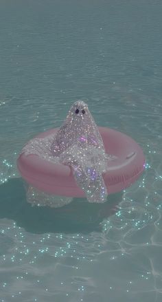 an inflatable object floating on top of the water with bubbles around it's head