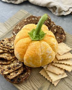 a pumpkin sitting on top of bread next to crackers