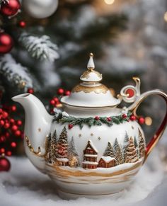 a christmas teapot sitting on top of snow covered ground