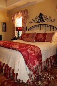 a bed with red and white bedspread in a bedroom