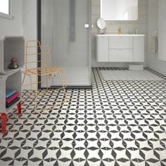 a bathroom with black and white floor tiles