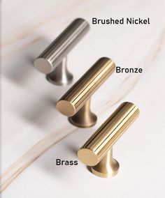 three different types of brass and bronze door knobs on a white surface with text below