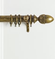 an antique brass door handle on a white door