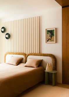 a bed sitting in a bedroom next to a wall with vertical blinds on it's sides