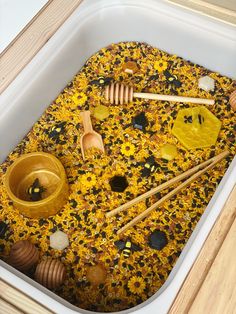 a bathtub filled with honey and wooden spoons