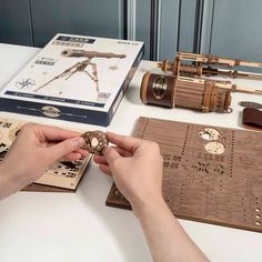 a person is working on some type of project with wood and metal parts in front of them