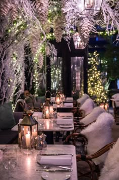 a long table is set with candles and place settings