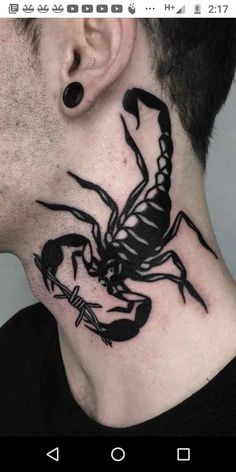 a man's neck with a scorpion tattoo on the back of his neck and behind his ear