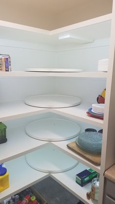 the shelves in this kitchen are filled with various items and containers, including plates and bowls