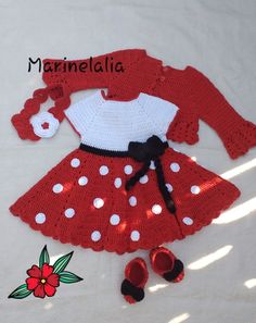 a crocheted red and white dress with polka dots on the skirt, shoes and cardigan