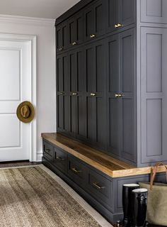 an image of a kitchen with gray cabinets and wood counter tops on the bottom shelf