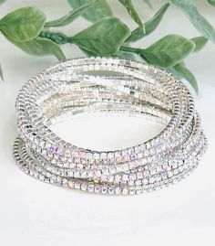 Order includes 12 Dainty Iridescent Rhinestone Stretch Bracelets in Silver Stretch Band to Fit Most Sizes Fitting and comfortable!  Fabulous Dressed Up or Down  Arrives in Gift Box Fast shipping Iridescent Bracelet For Party, Silver Stackable Stretch Bracelet For Parties, Adjustable Iridescent Crystal Bracelets, Adjustable Iridescent Bracelet For Parties, Silver Prom Jewelry, Bracelet Set Silver, Bracelets Silver, Silver Bling, Prom Jewelry