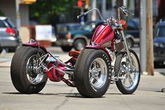 a red motorcycle is parked on the street