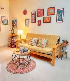 a living room filled with lots of furniture and pictures on the wall above it's coffee table