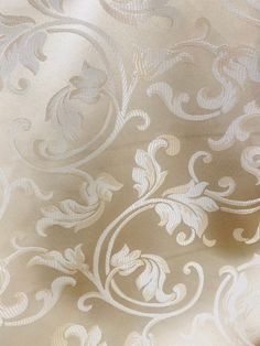 a close up view of a white fabric with an intricate design on it's surface