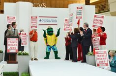 people holding signs and standing on stage at convention