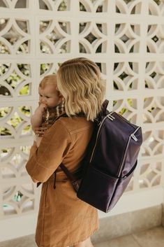 a woman carrying a baby in her back pack