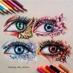 some colored pencils are next to an eye