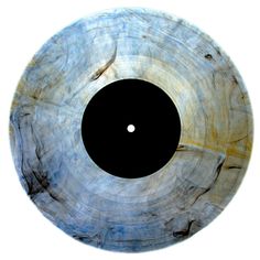 a black hole in the center of a wooden object with white and blue streaks on it