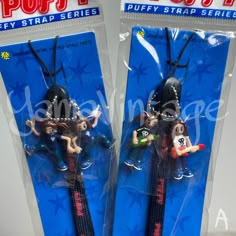 two plastic keychains with cartoon characters on them in the packaging for pop - up toys