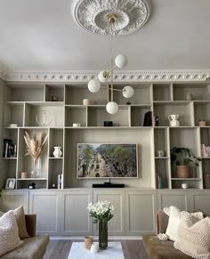 a living room filled with furniture and lots of shelves